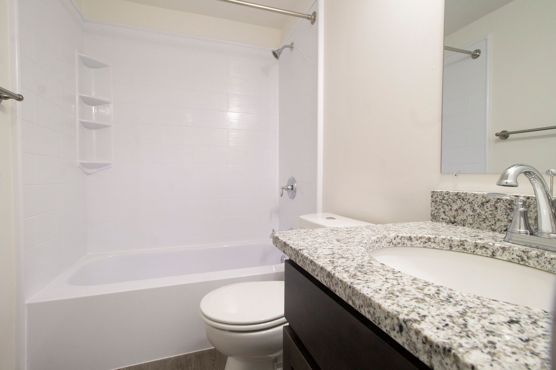 A bathroom with a toilet , sink , and bathtub.