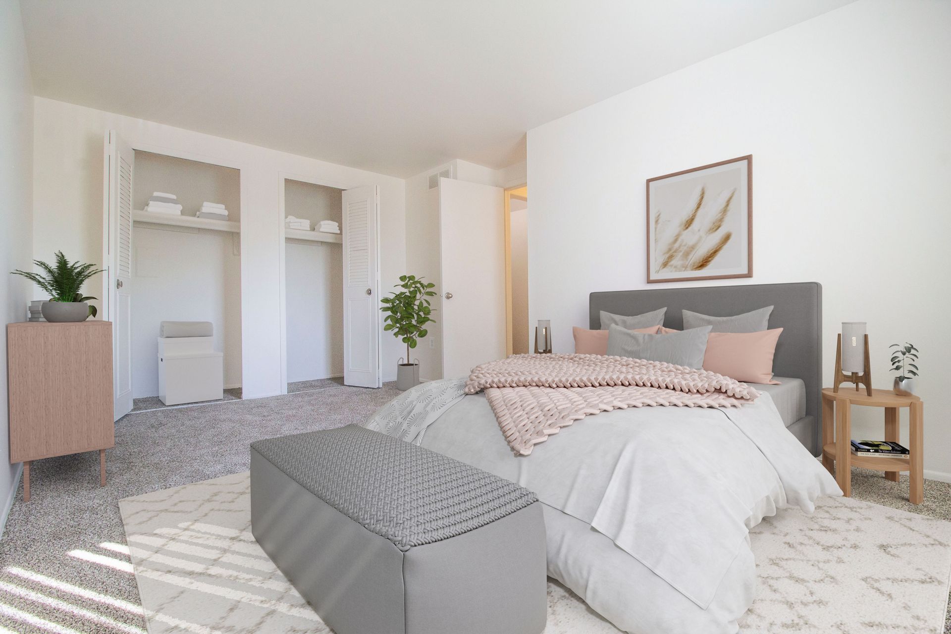 A bedroom with a bed , dresser , nightstand and ottoman.