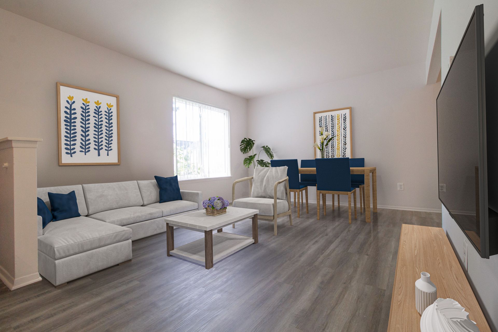 A living room with a couch , table , chairs and a flat screen tv.