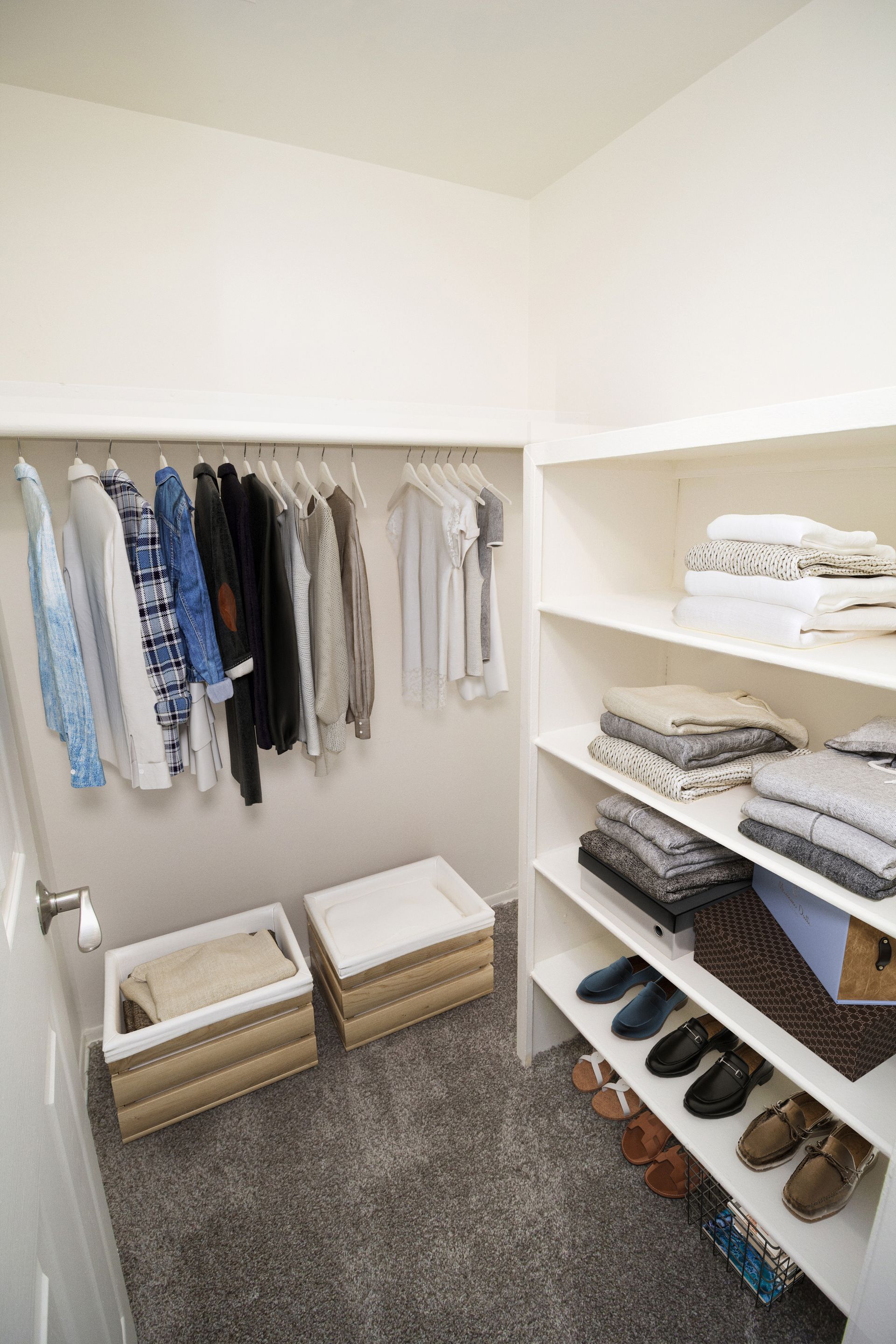 A walk in closet filled with clothes and shoes.