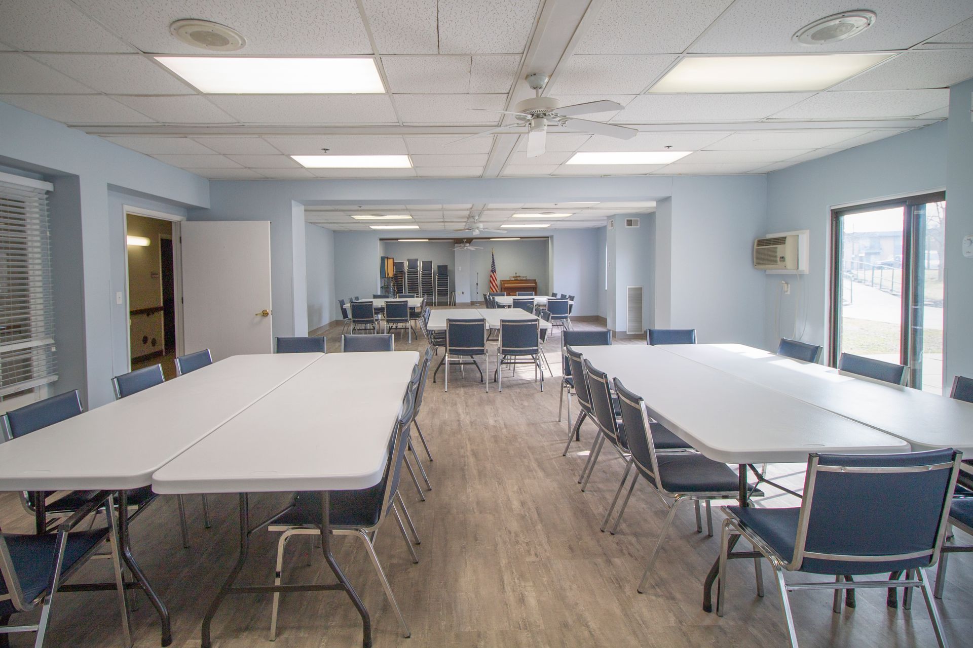 A large room with tables and chairs in it.