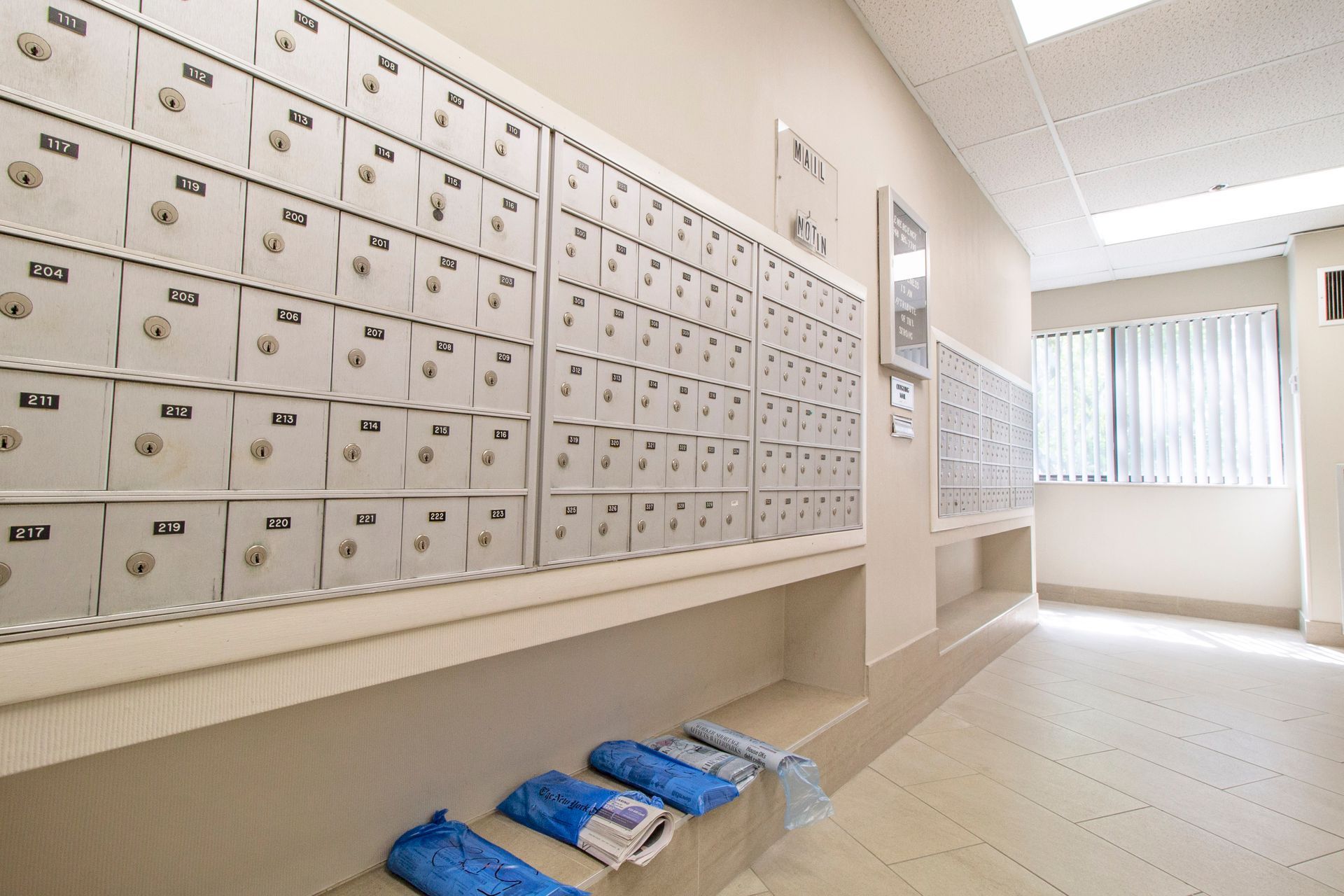 A hallway with a lot of mailboxes on the wall
