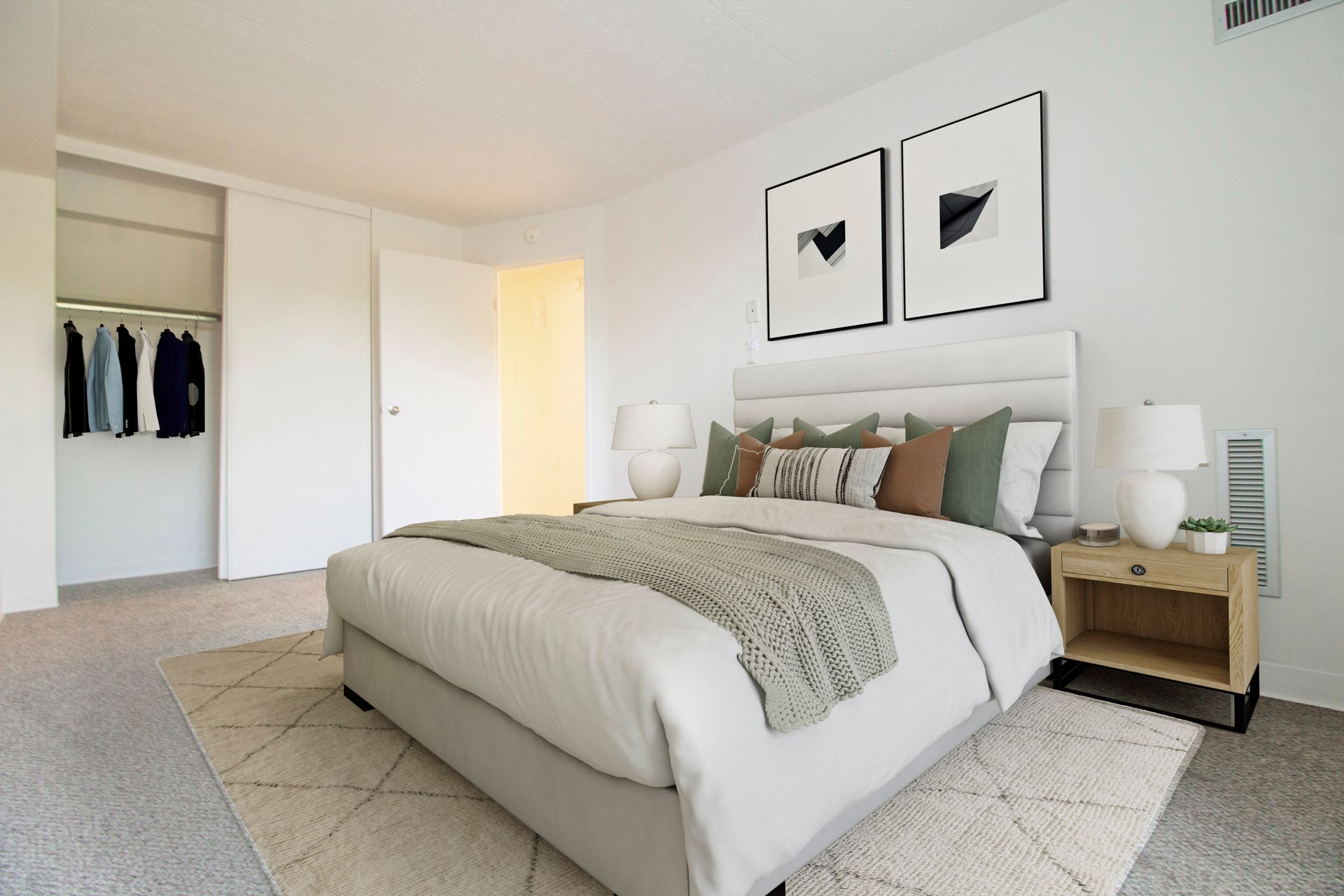 A bedroom with a large bed and a closet.