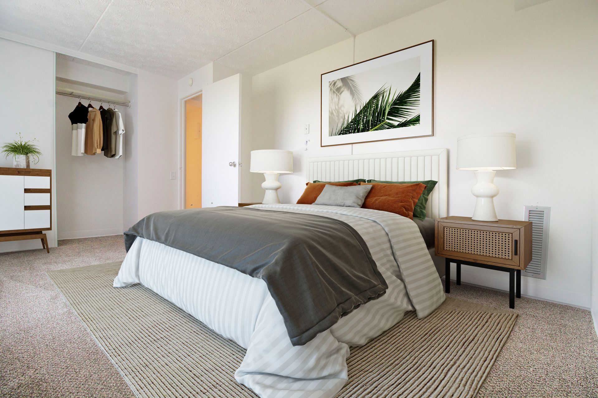 A bedroom with a bed , nightstand , dresser and closet.