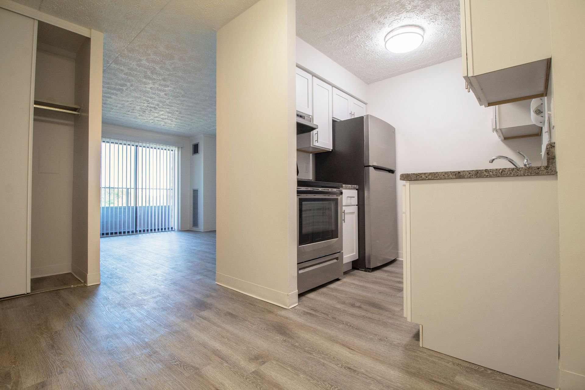 A kitchen with stainless steel appliances and white cabinets