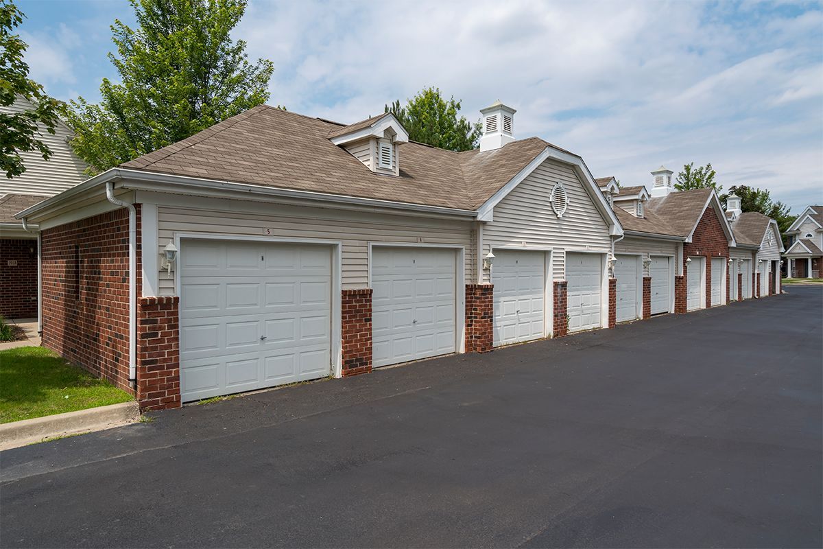 A row of garages are lined up next to each other in a residential area.