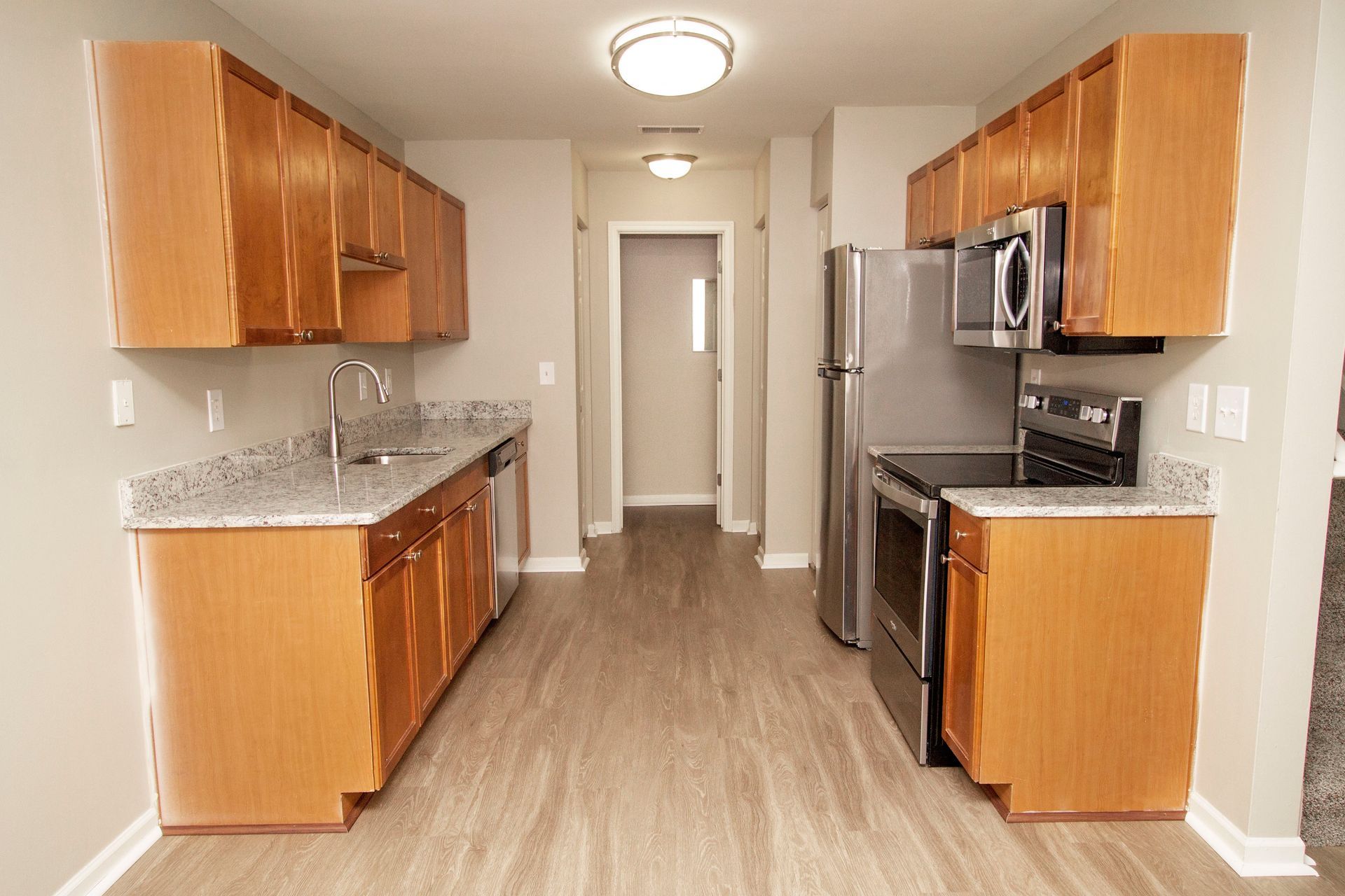 A kitchen with wooden cabinets and stainless steel appliances.
