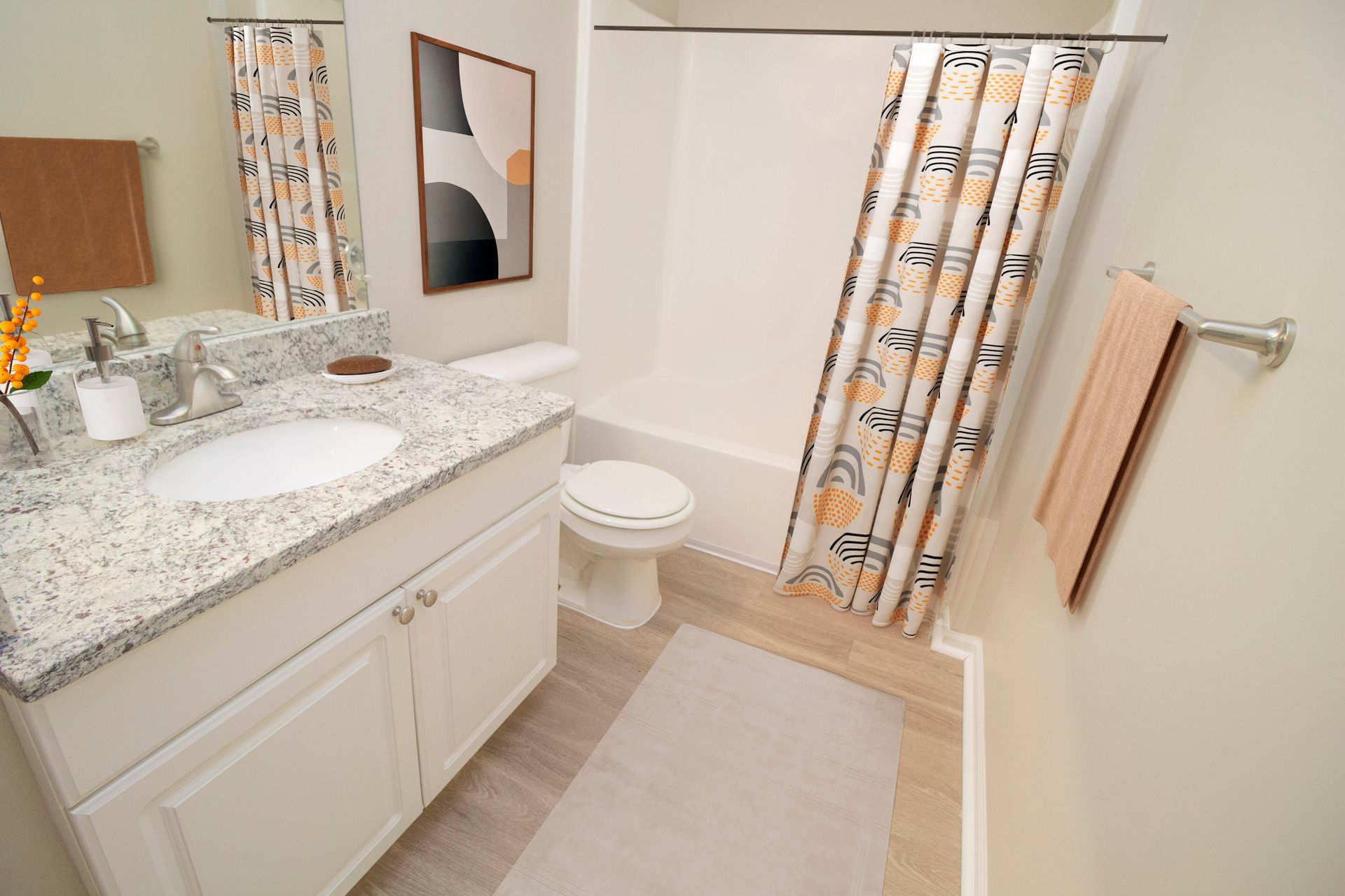 A bathroom with a sink , toilet , bathtub and shower curtain.