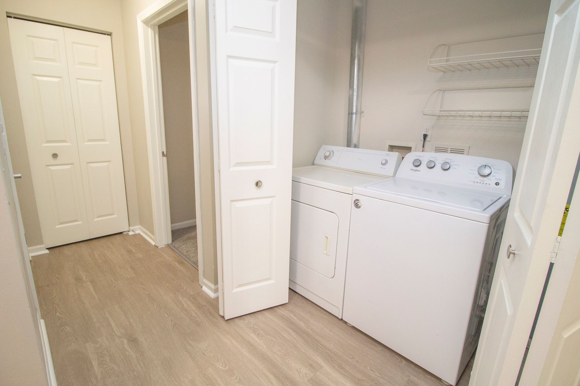 A laundry room with a washer and dryer in a house.