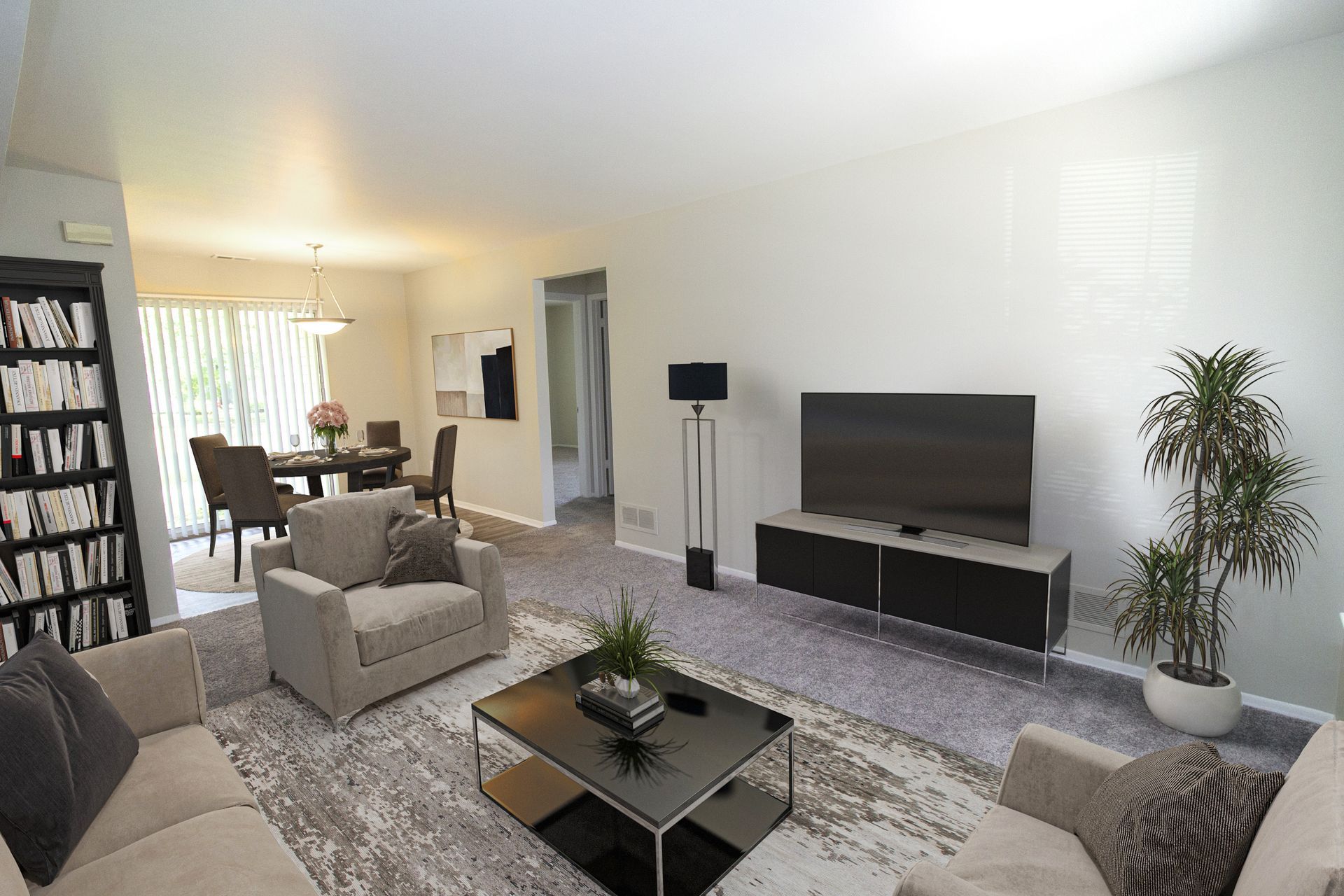A living room with a couch , chair , coffee table and television.