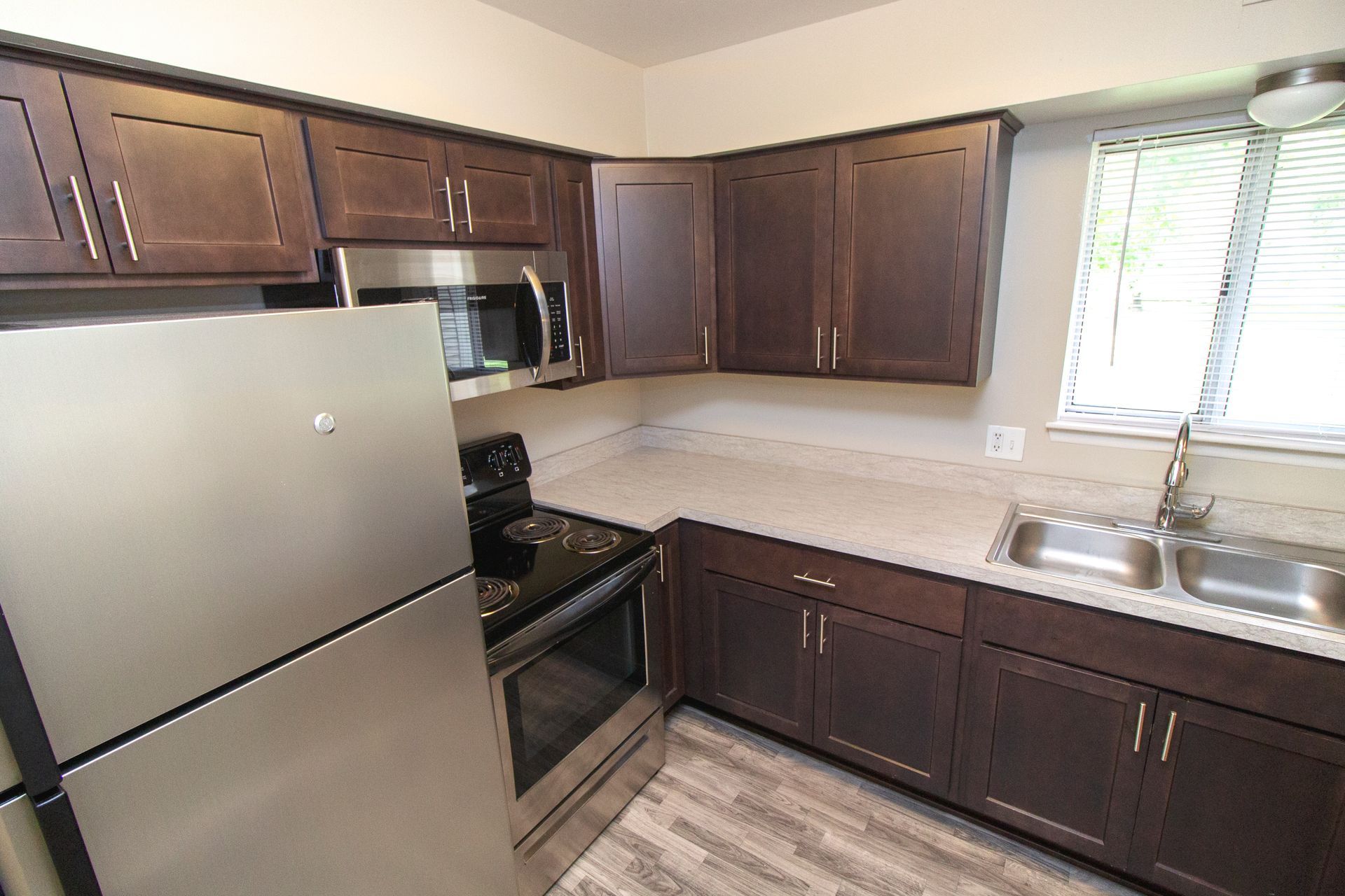 A kitchen with stainless steel appliances and wooden cabinets