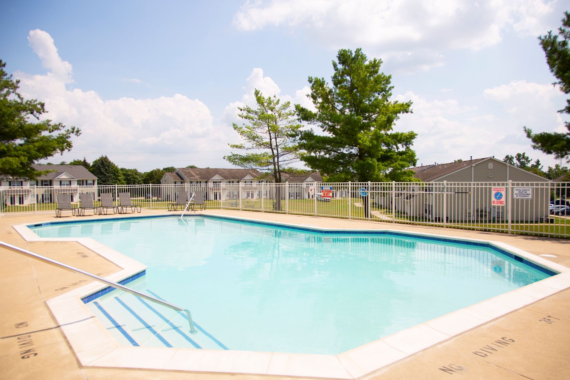 A large swimming pool with a fence around it