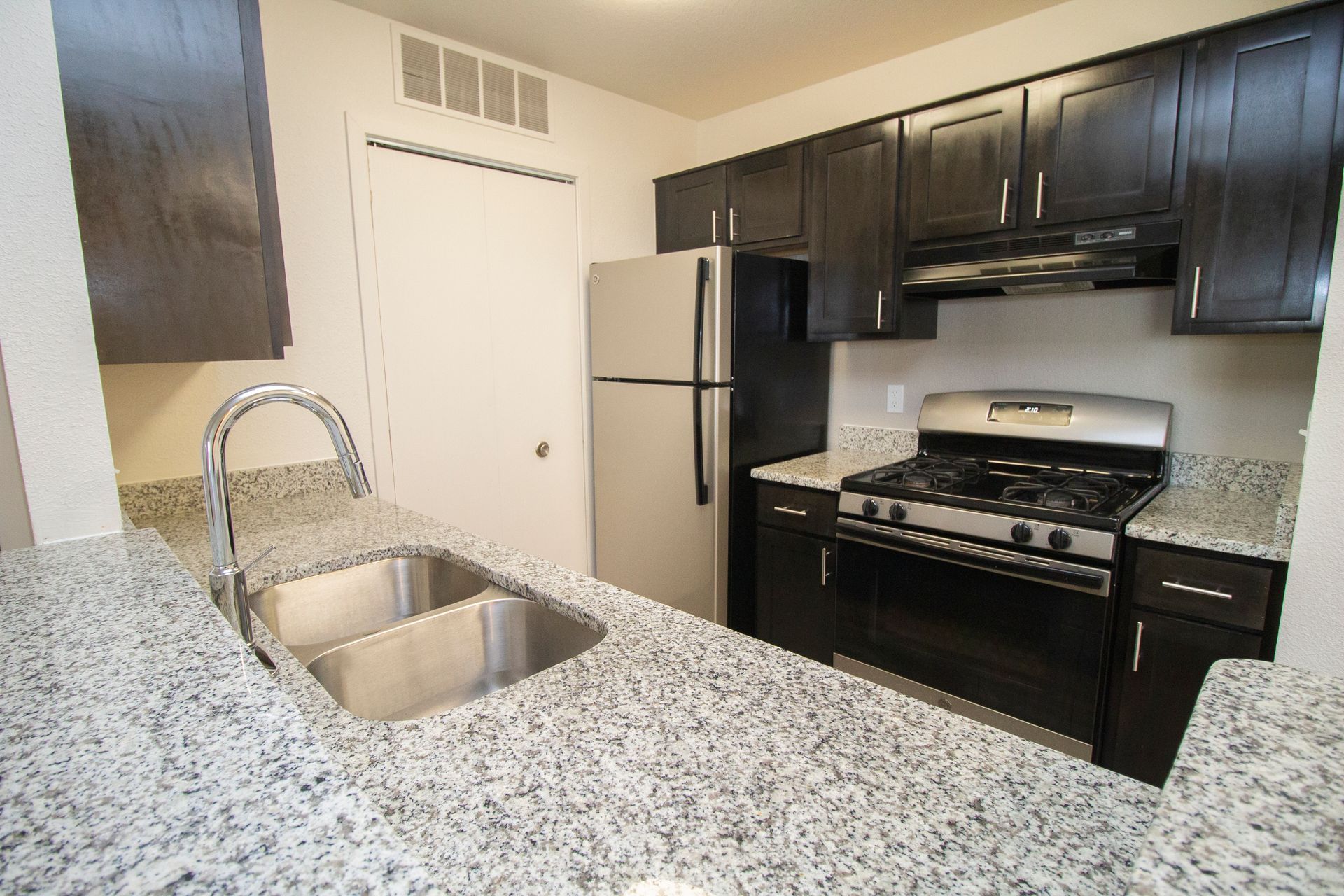 A kitchen with stainless steel appliances and granite counter tops