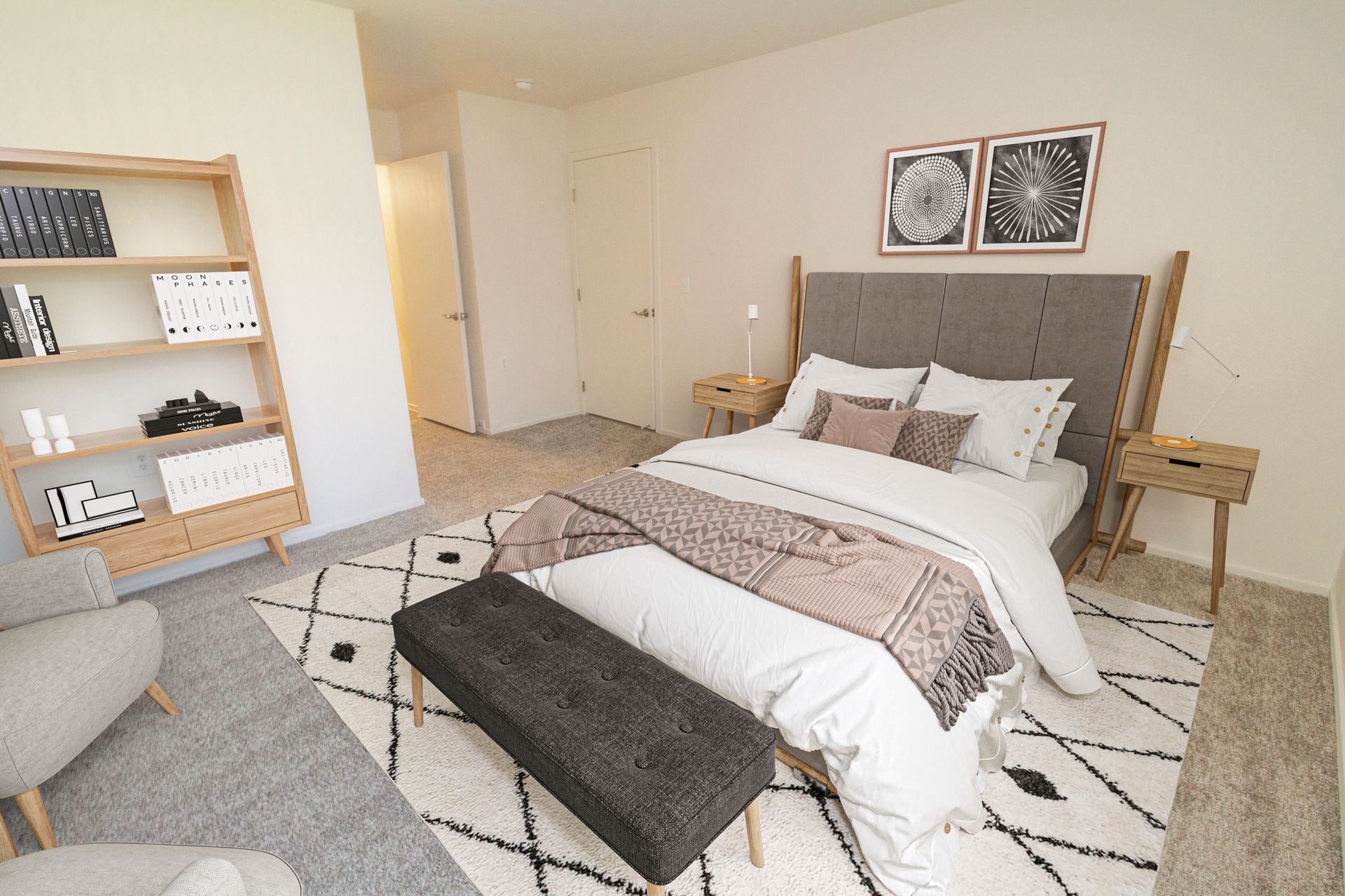 A bedroom with a large bed , a bench , a chair and a bookshelf.