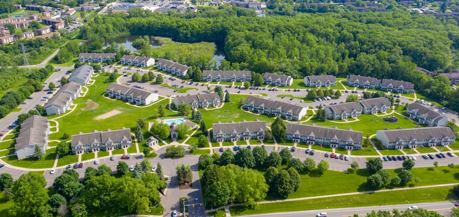 An aerial view of a residential area with lots of trees and buildings.