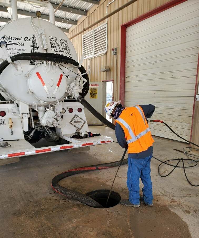 Man Cleaning Tank — Somerset, TX — Approved Oil Services LLC