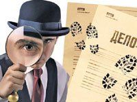 A man in a hat is looking through a magnifying glass at footprints on a piece of paper.