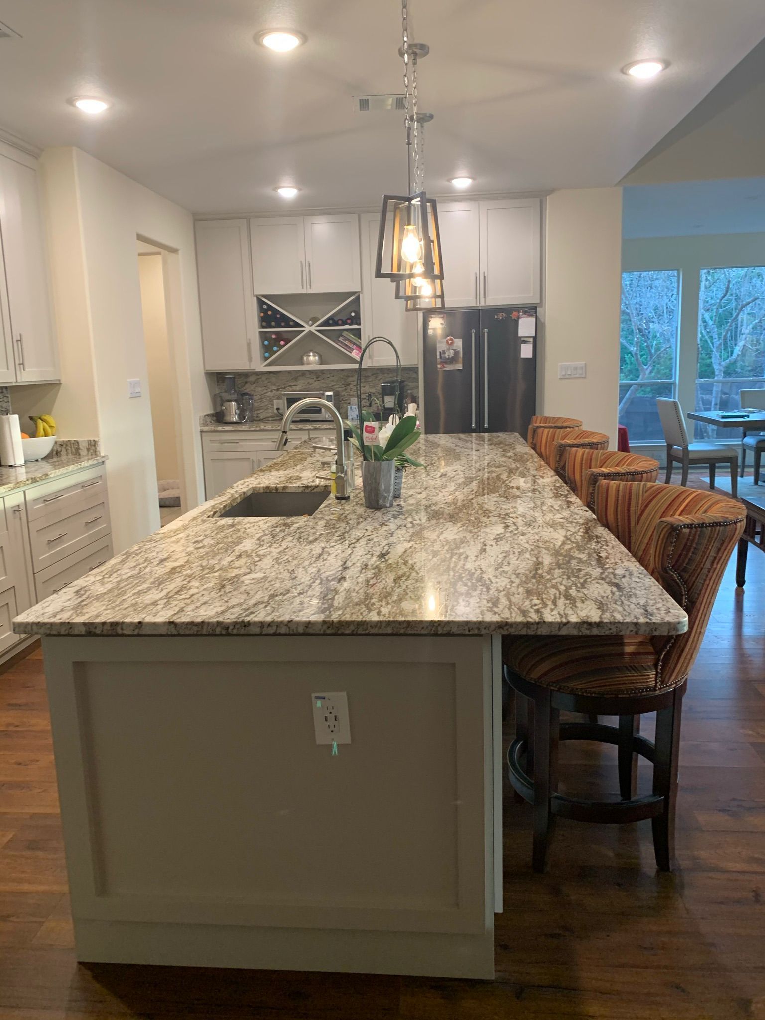 A kitchen with a large granite counter top and a sink.