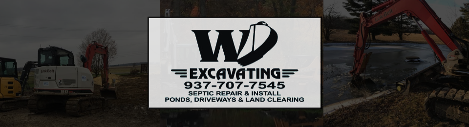 WD Excavating logo on a white sign over a dark construction site with excavator and dump truck