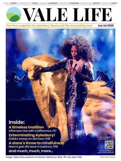 Cover of Vale Life magazine featuring a performer with an afro and sequined dress on stage, with text about local topics.