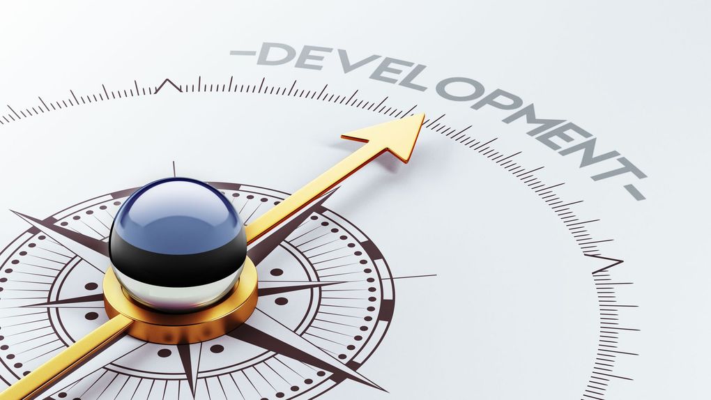 A compass with an arrow pointing to the word development