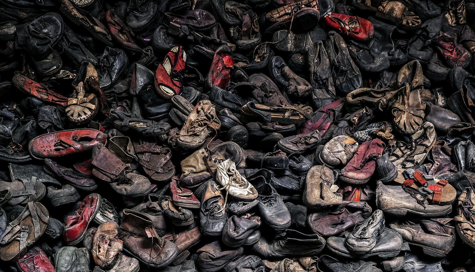 A pile of old shoes sitting on top of each other.