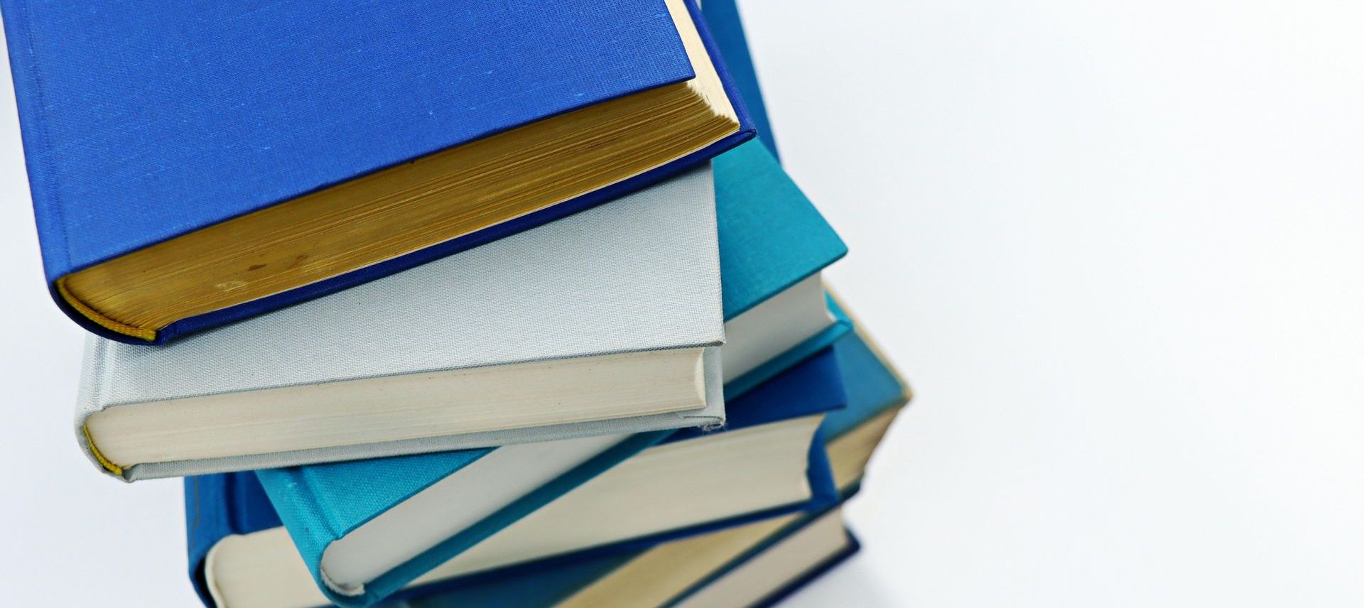 A stack of blue and white books on a white background.