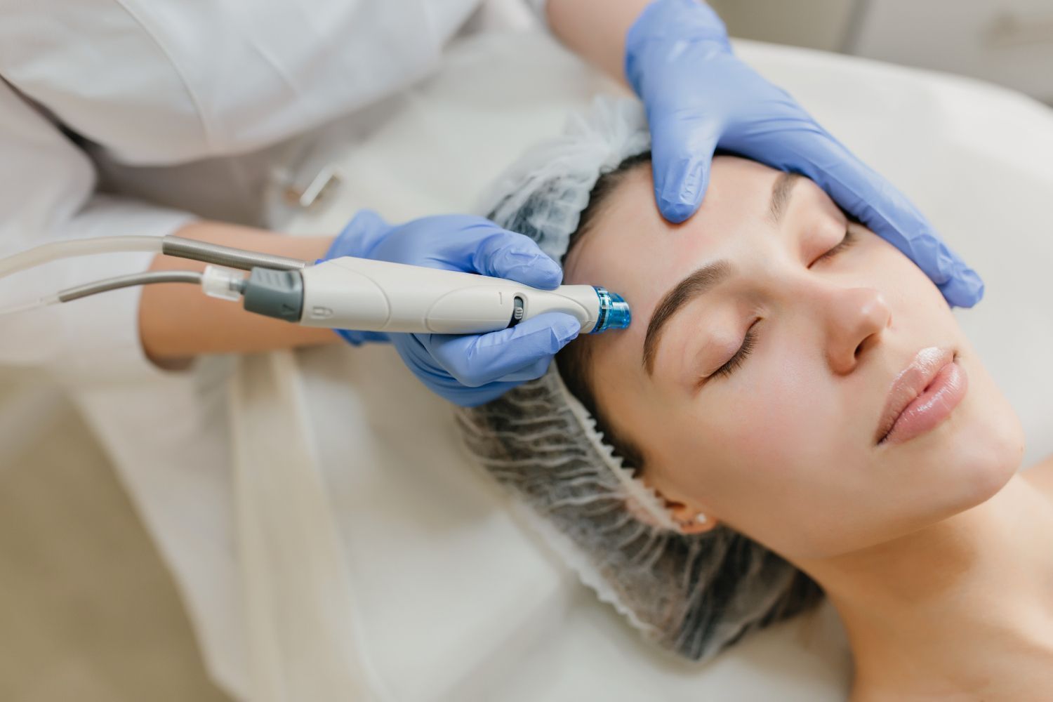 A woman is getting a facial treatment at a beauty salon.