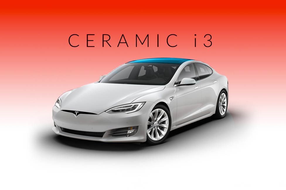 A white tesla model s with a blue roof on a red background.