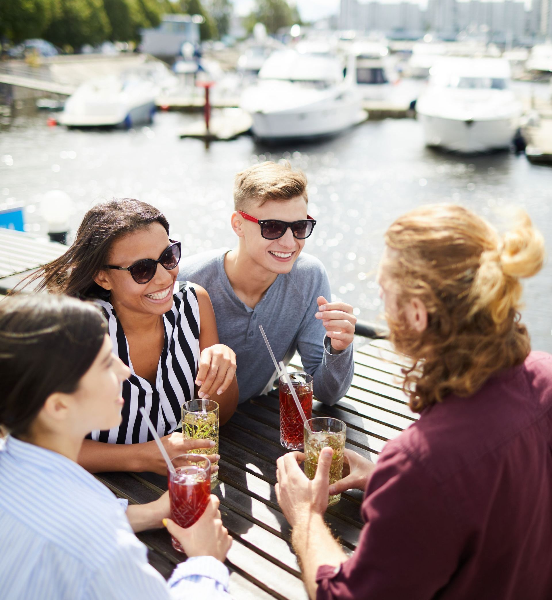 A group of people are sitting at a table drinking drinks