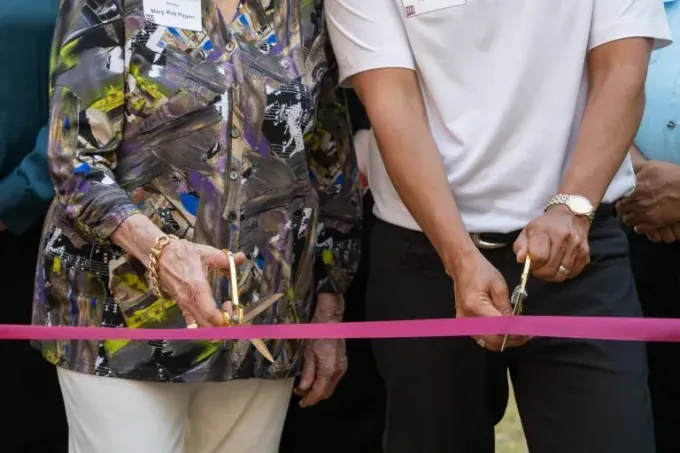 Community leader Abel Covarrubias and Elke Wunderlich cutting a ceremonial ribbon.