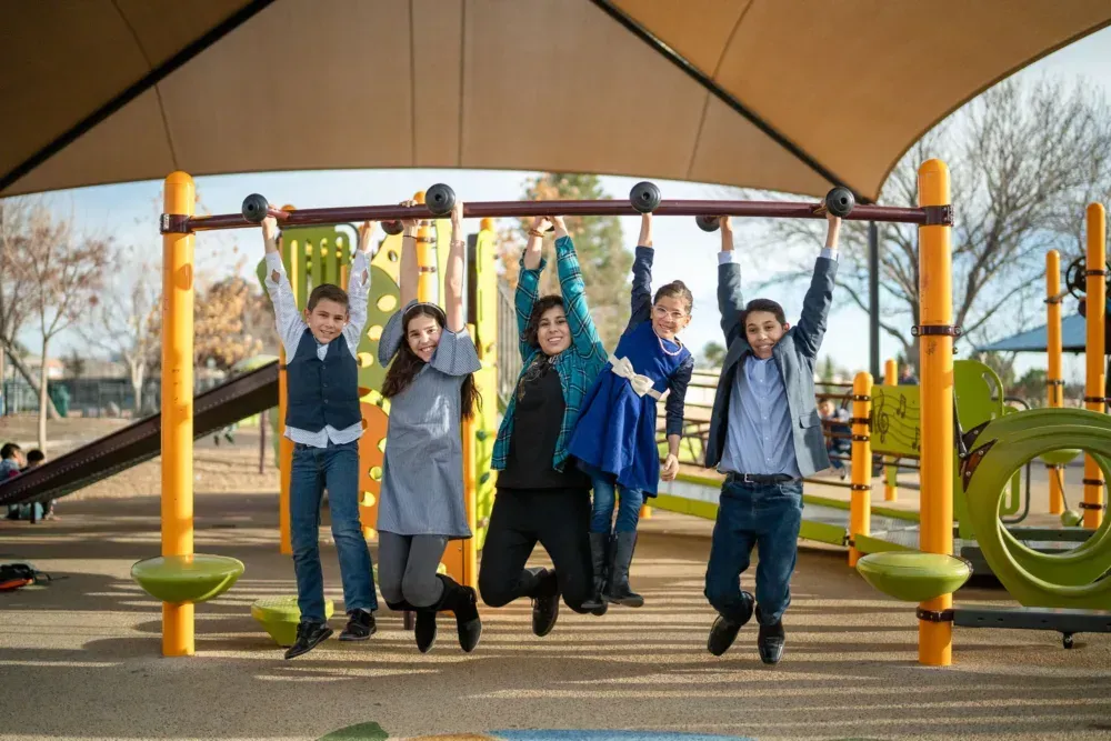 A group of children are playing at a playground.