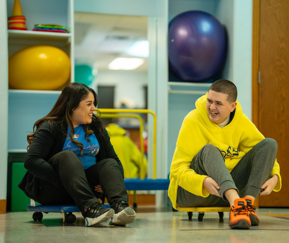 Noah and therapist during a therapy session at the Mariposa Autism Service Center building