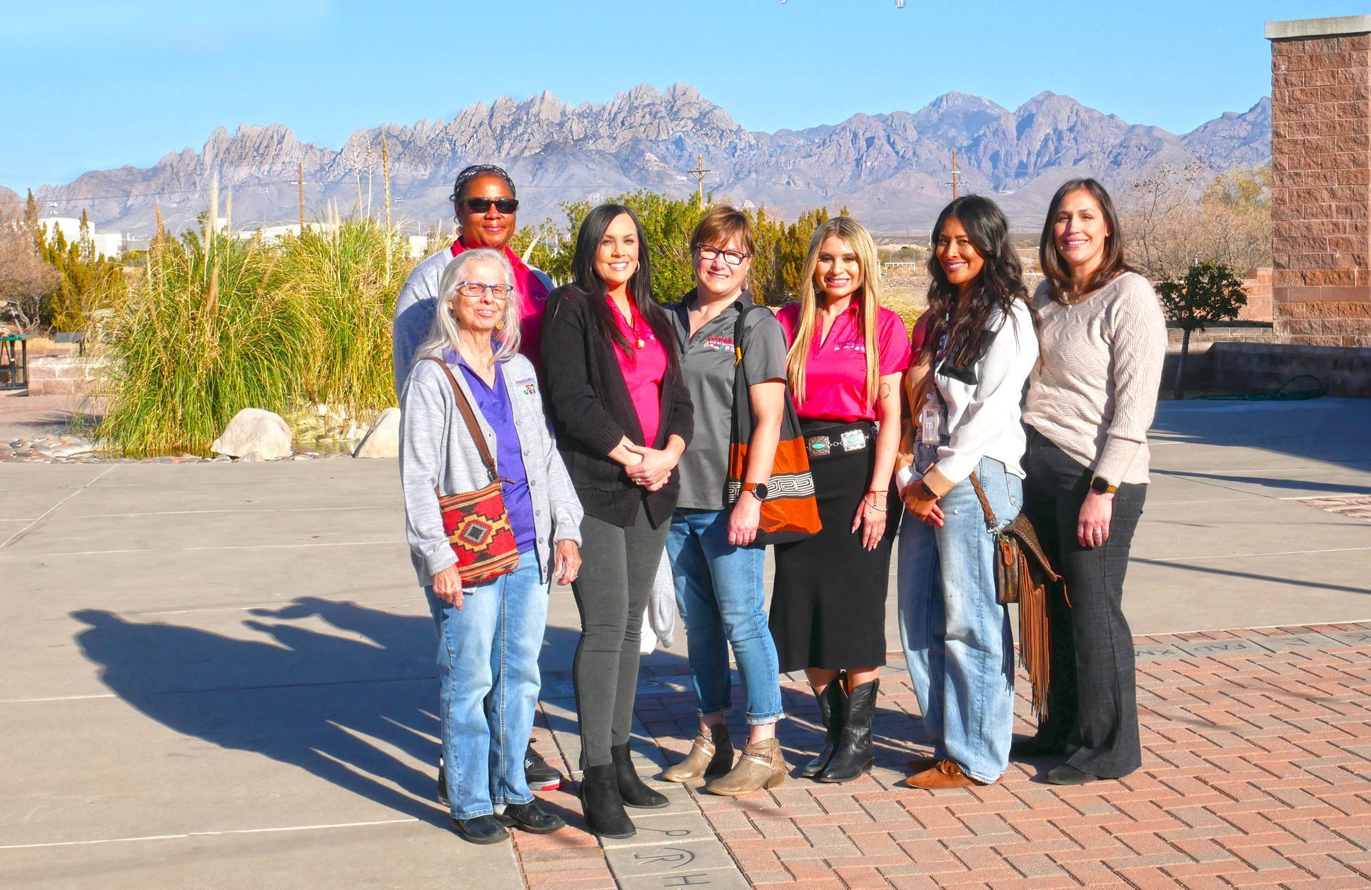 The Alegría Family Counseling team standing together outdoors with the Las Cruces Organ Mountains in the background.