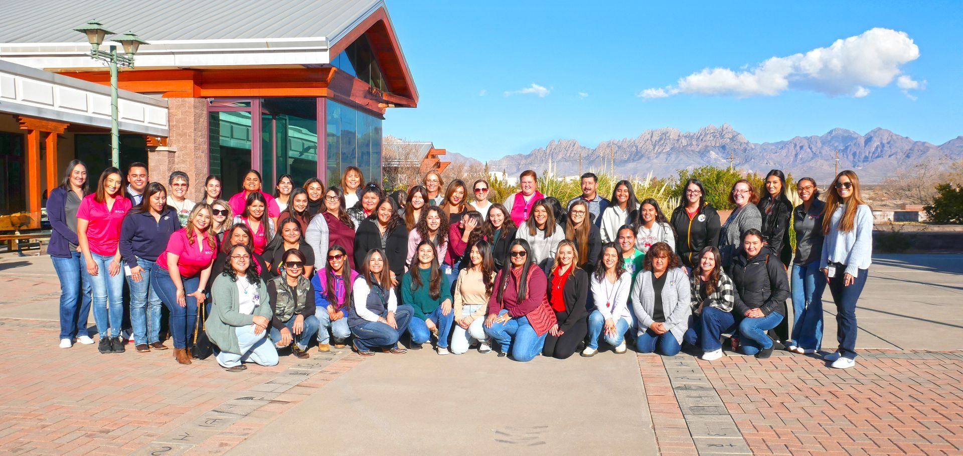 The Aprendamos Early Intervention team outdoors with the Las Cruces Organ Mountains in the background.