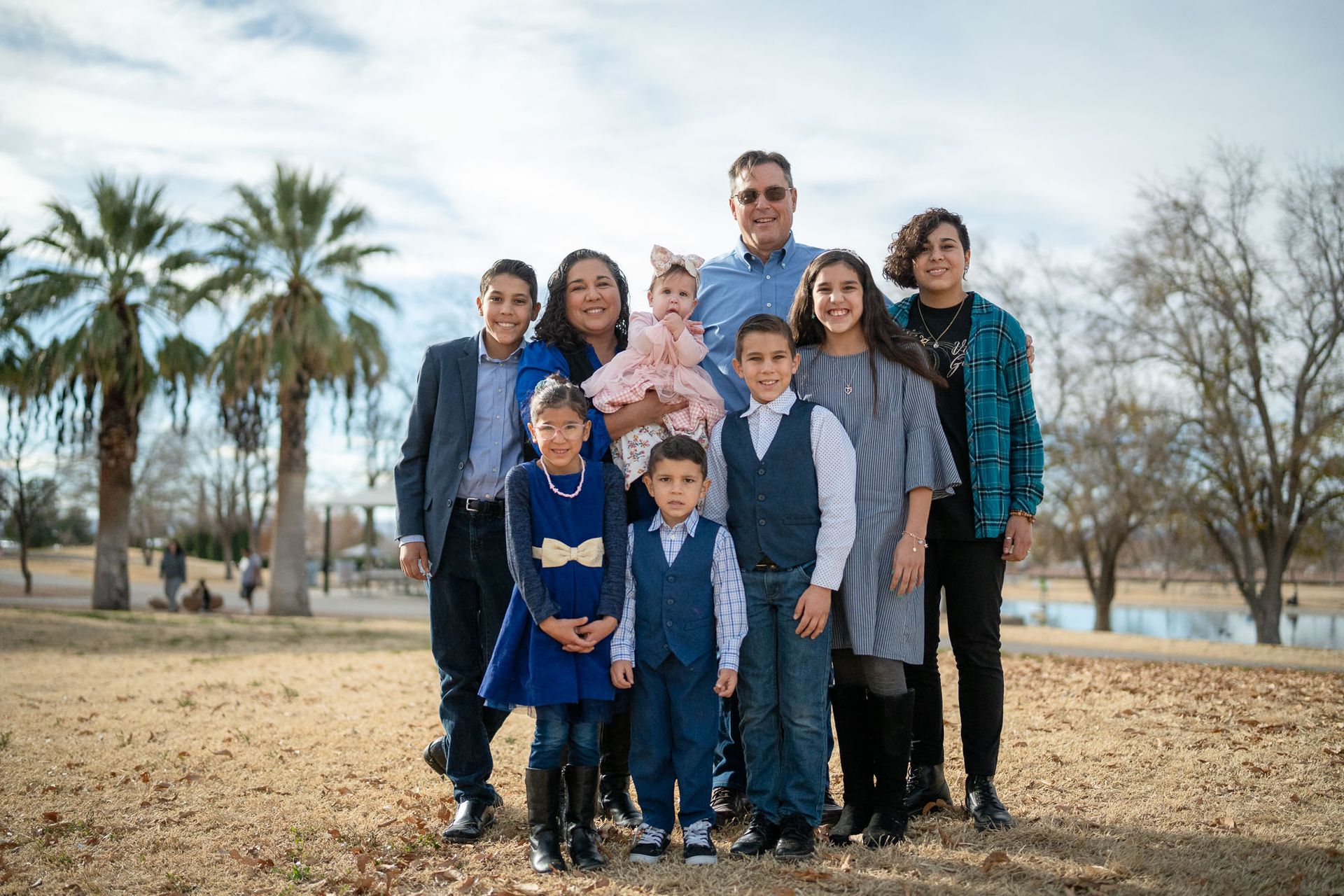 Smiling multigenerational family gathered outdoors, symbolizing holistic support and emotional wellness.