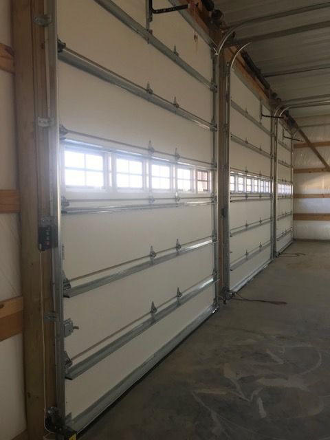 A row of garage doors with a lot of windows