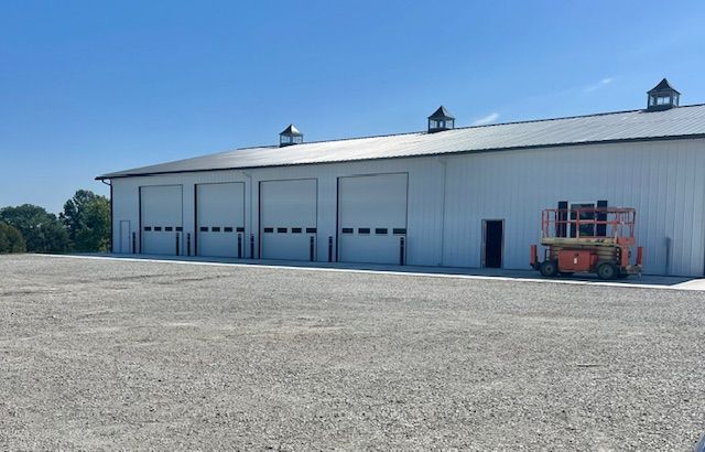 A large white building with a lot of garage doors