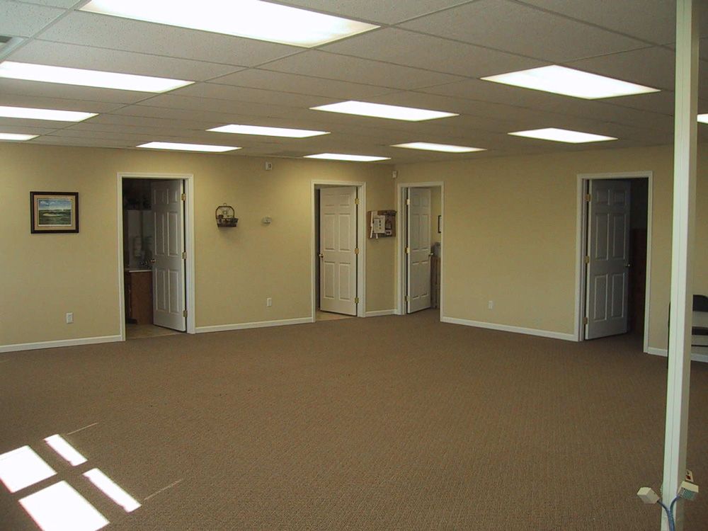 A large empty room with a picture on the wall