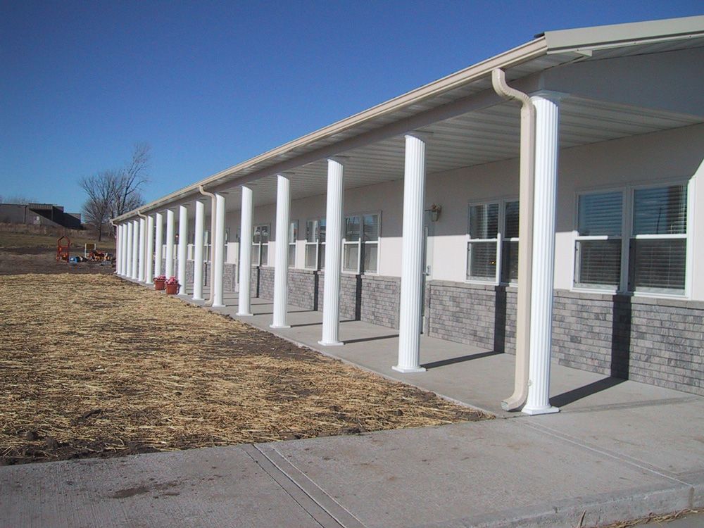 A building with a long porch and a lot of windows