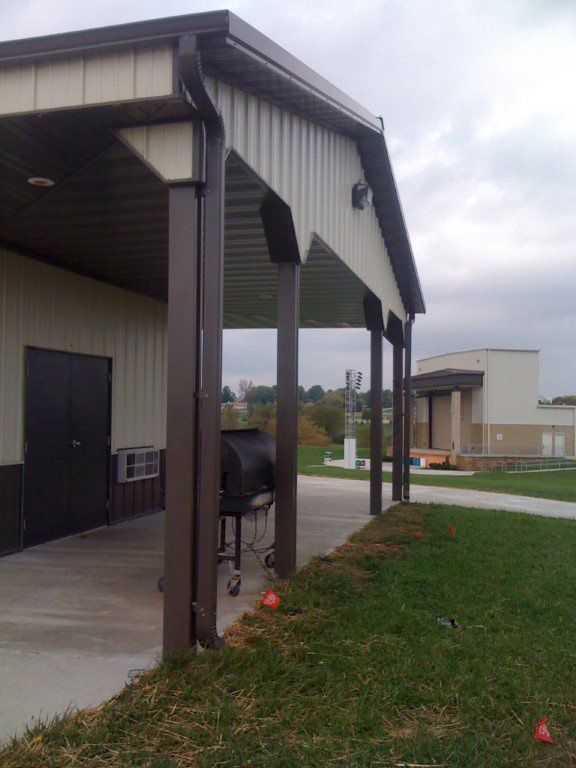 A covered area with a grill underneath it