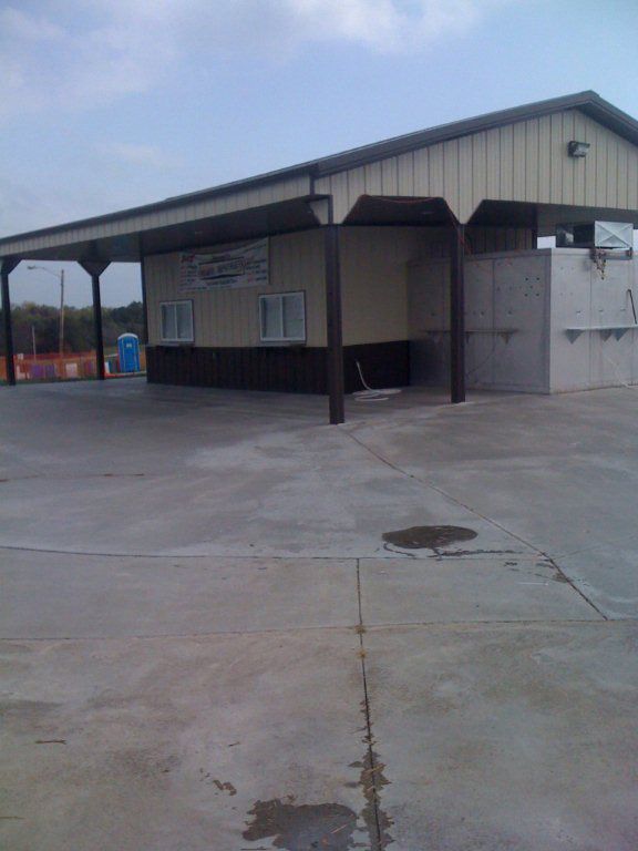 A large building with a concrete driveway in front of it