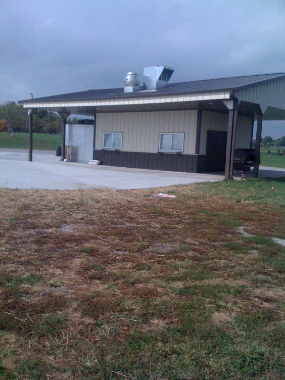 A large building with a covered area in front of it