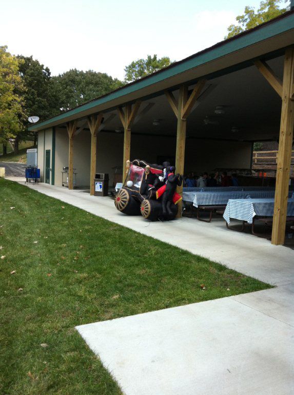 A tractor is parked in front of a pavilion