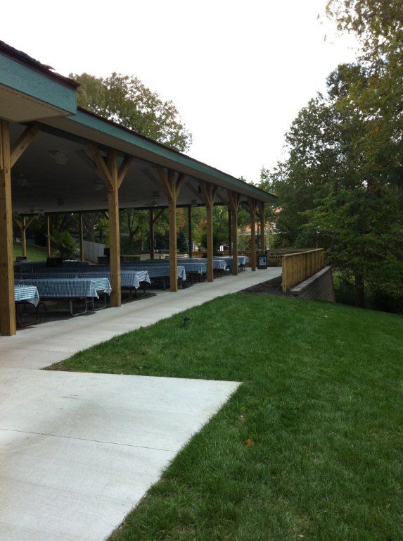 A row of tables under a covered area in a park