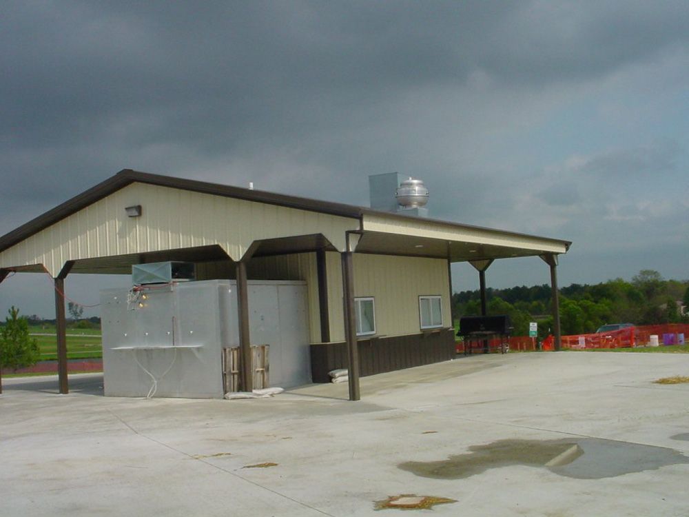 A building with a roof that has a fan on top of it