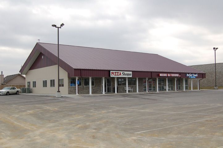 A building with a purple roof and a sign that says pizza shoppe