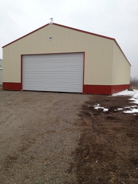 A white and red building with a large garage door