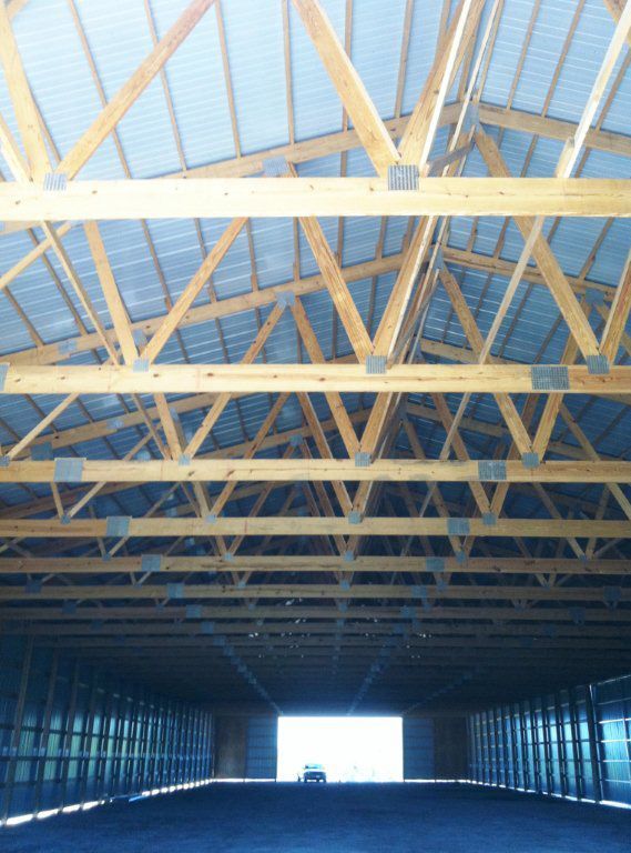 The inside of a building with a car in the doorway