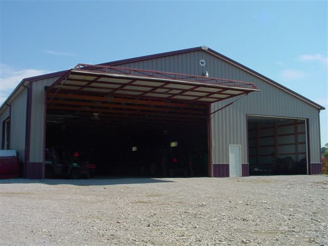 A large metal building with a roof that is open